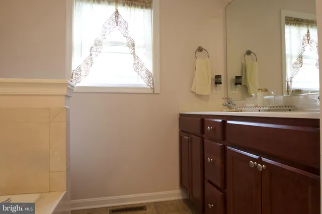 a bathroom with a sink a vanity and a mirror