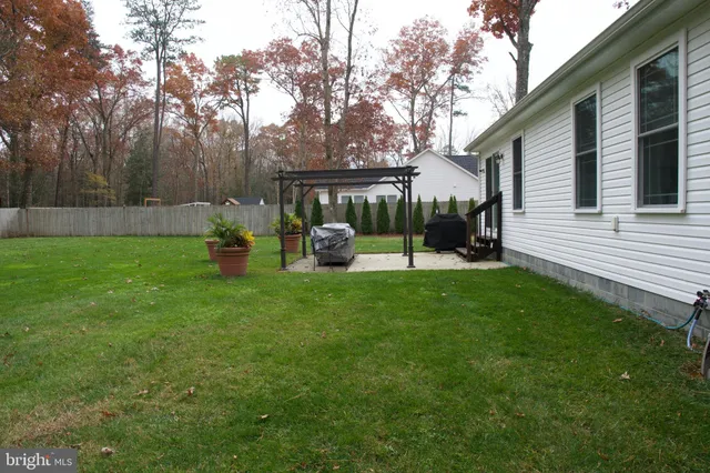a view of a backyard with sitting area
