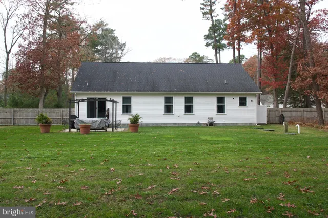 a front view of a house with a garden and yard