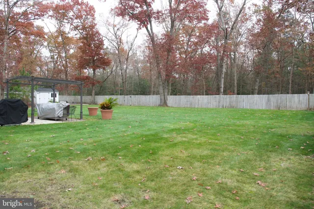 a view of a backyard with sitting area