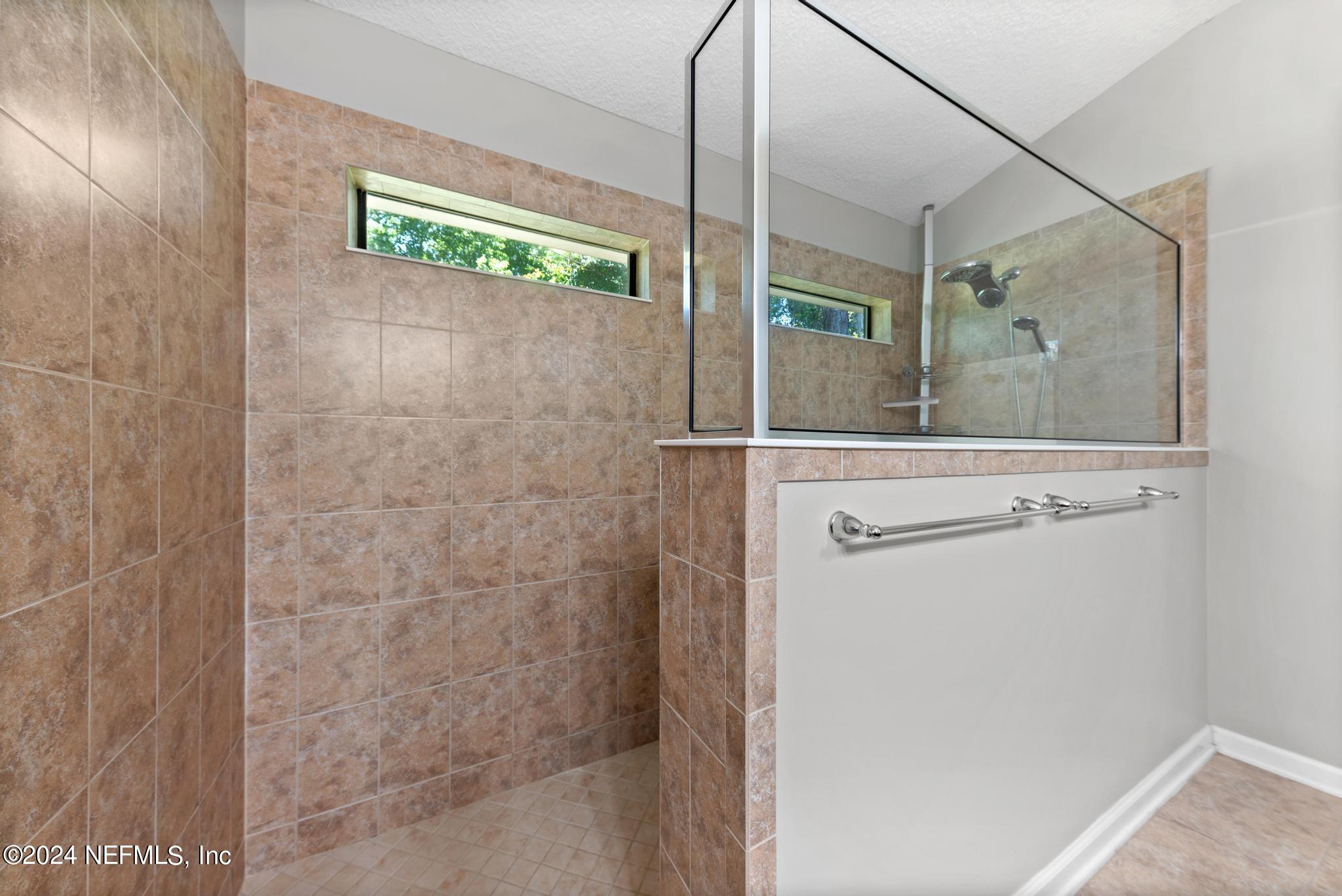 86192 Fortune Drive Yulee, FL 32097 - Photo 16 of 26 a bathroom with a shower and a sink