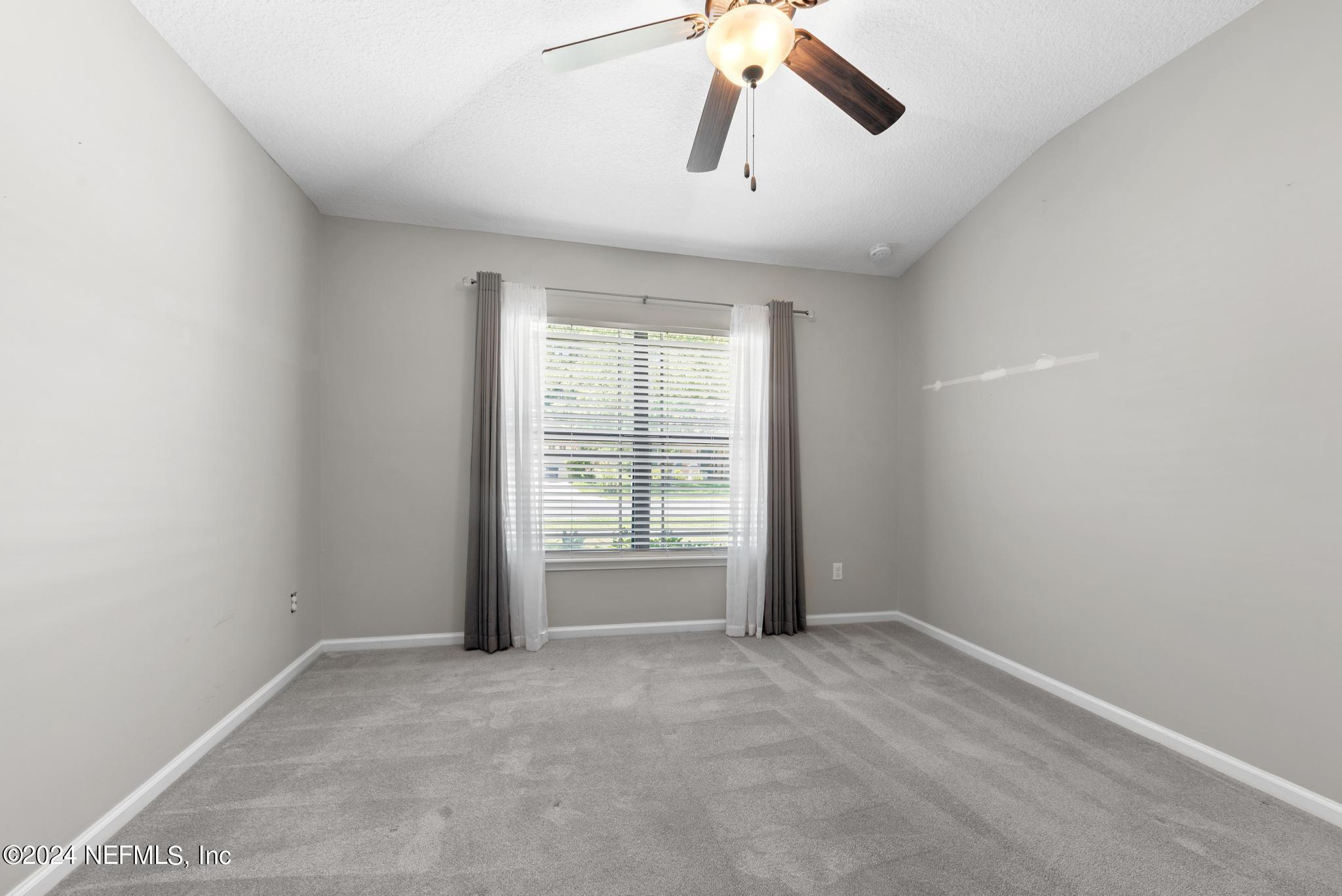 86192 Fortune Drive Yulee, FL 32097 - Photo 17 of 26 an empty room with windows and fan