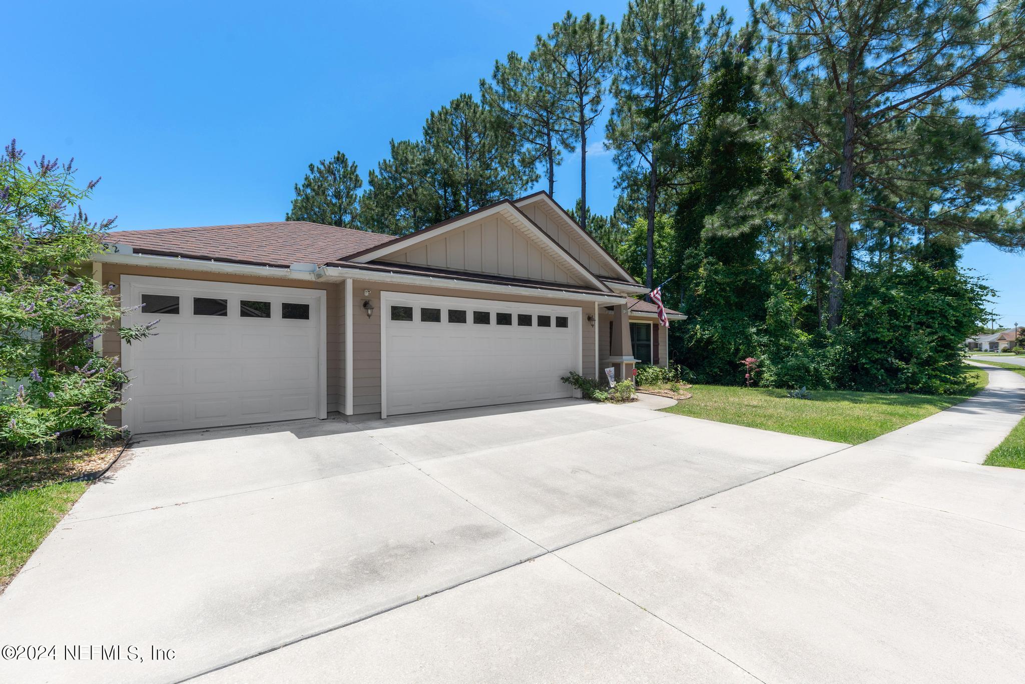 86192 Fortune Drive Yulee, FL 32097 - Photo 2 of 26 a front view of a house with a yard