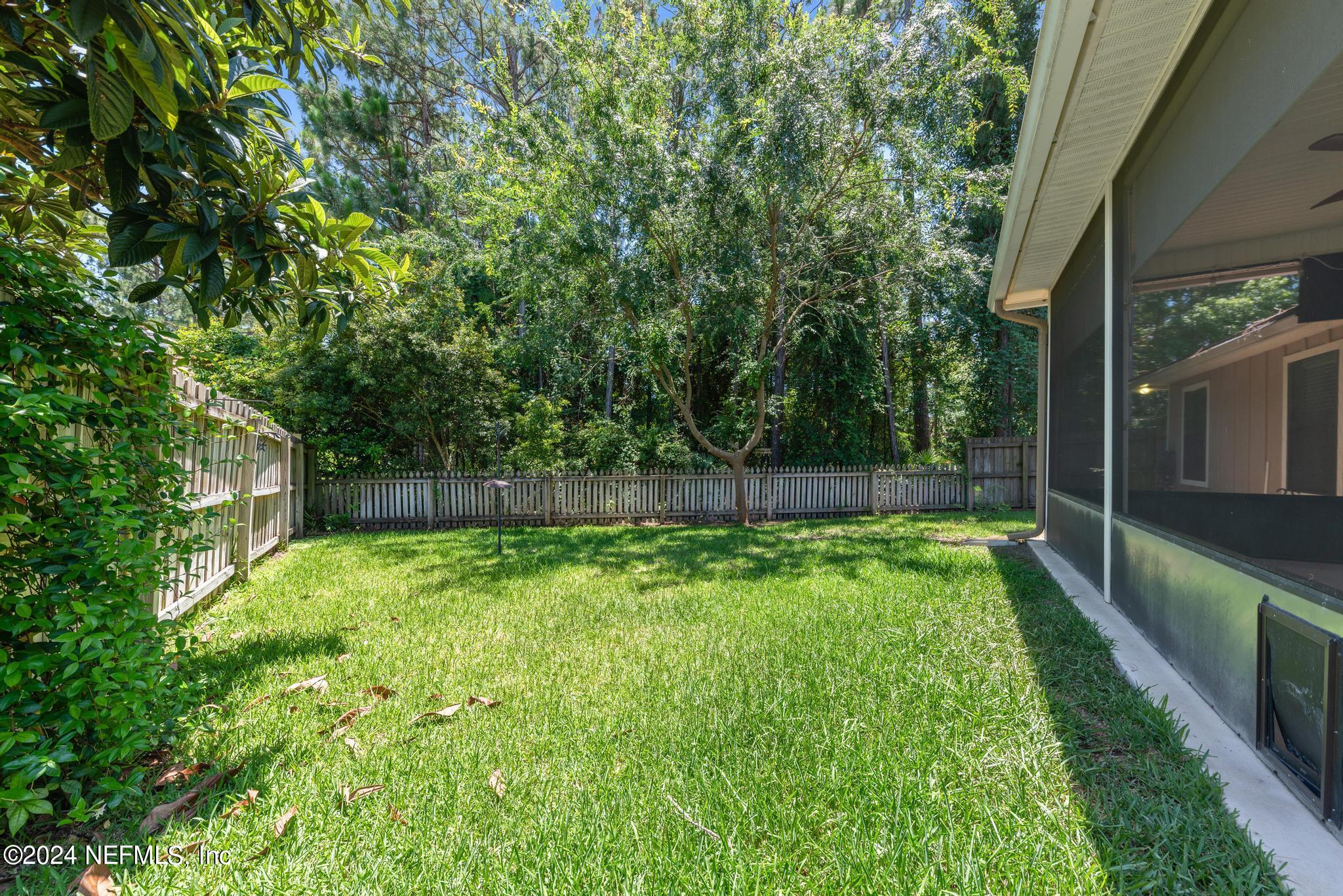 86192 Fortune Drive Yulee, FL 32097 - Photo 24 of 26 a backyard of a house with lots of green space