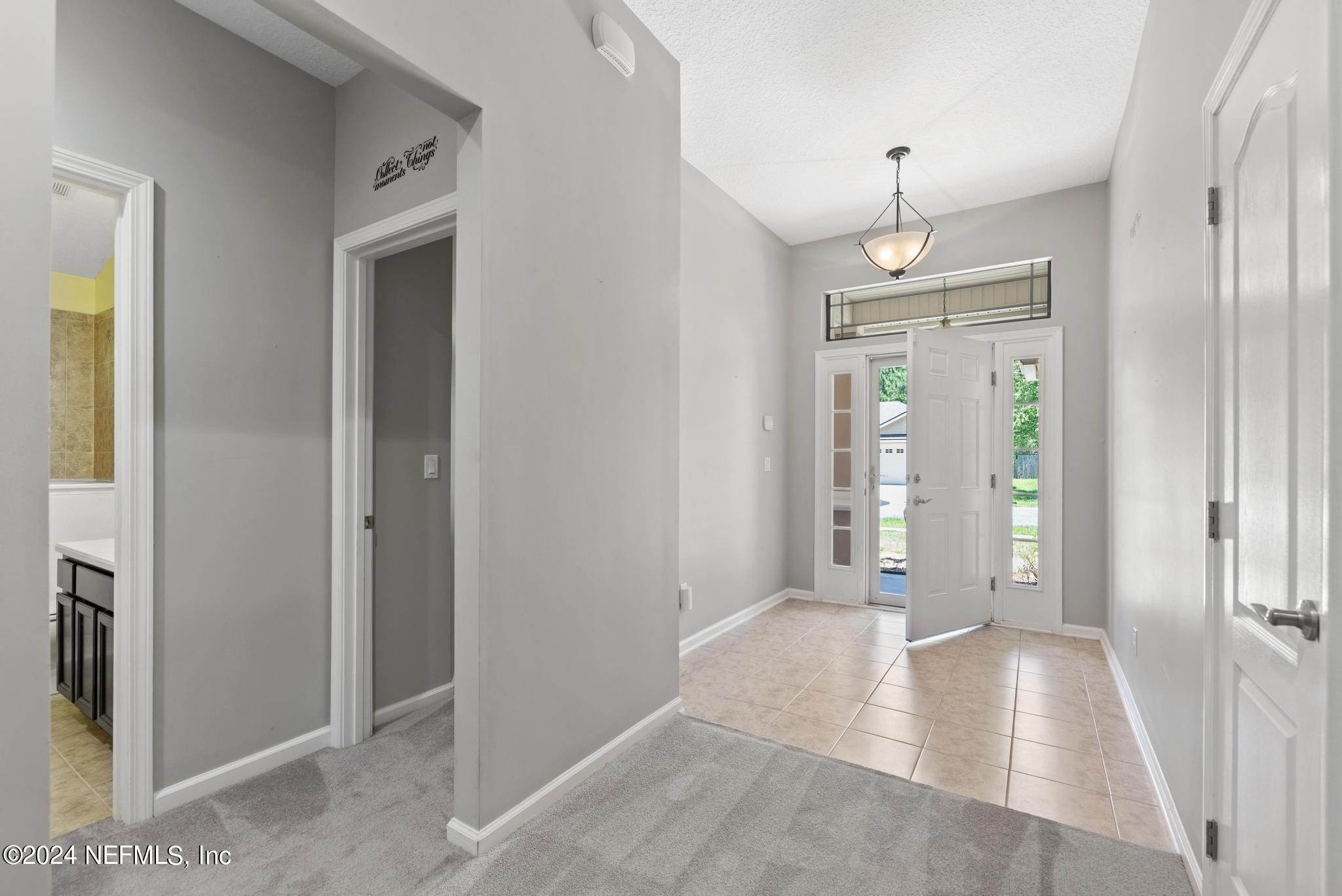 86192 Fortune Drive Yulee, FL 32097 - Photo 4 of 26 a view of a hallway with wooden shelves