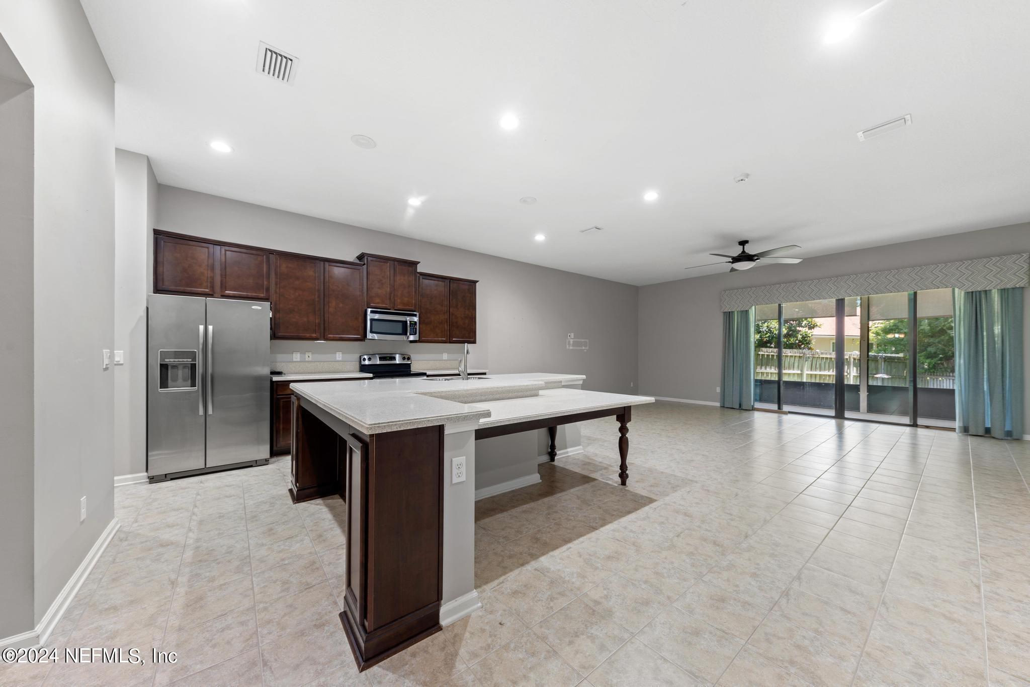 86192 Fortune Drive Yulee, FL 32097 - Photo 6 of 26 a kitchen with stainless steel appliances granite countertop a stove and a refrigerator