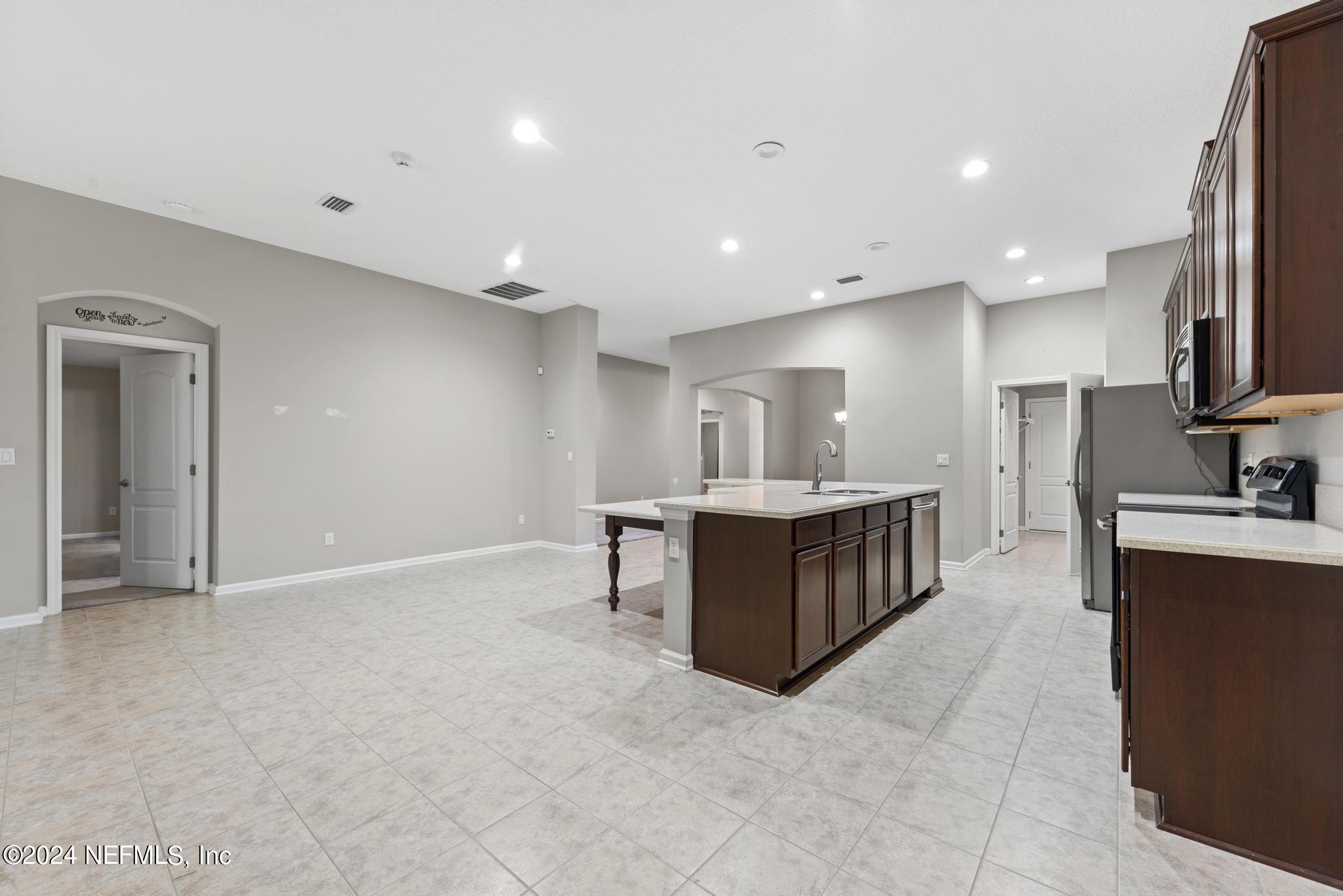 86192 Fortune Drive Yulee, FL 32097 - Photo 8 of 26 a large white kitchen with a large counter top stainless steel appliances and cabinets