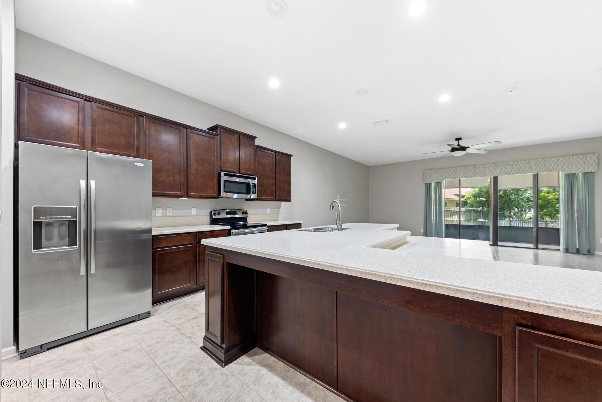 86192 Fortune Drive Yulee, FL 32097 - Photo 10 of 26 a kitchen with stainless steel appliances granite countertop a sink stove and refrigerator