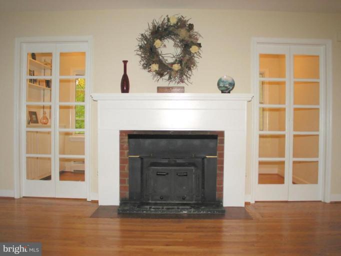 16531 Batchellors Forest Road Olney, MD 20832 - Photo 11 of 30 Brick fireplace with wood stove insert