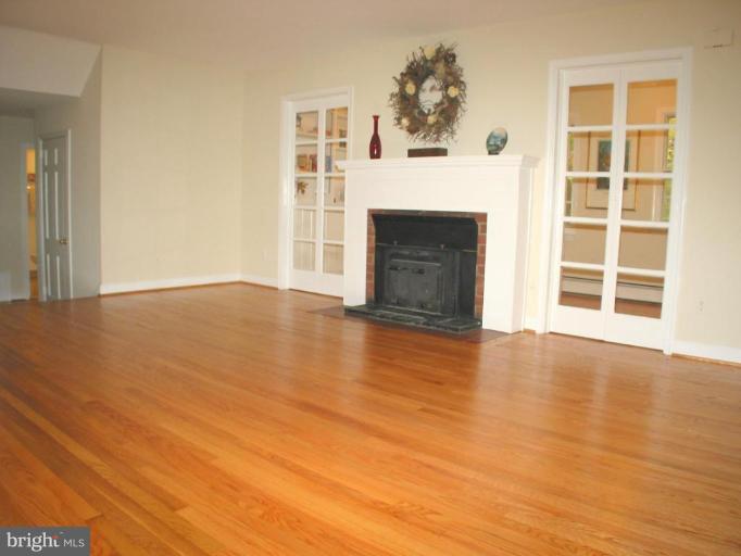 16531 Batchellors Forest Road Olney, MD 20832 - Photo 3 of 30 Gleaming Wood Floor and Brick Fireplace