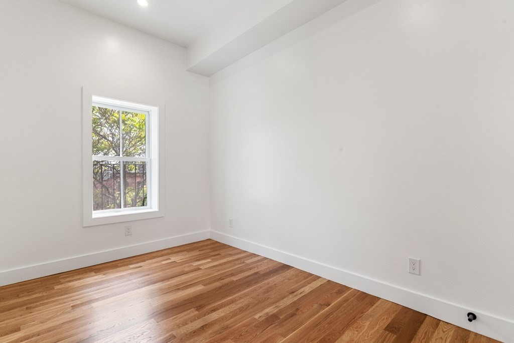 7 Columbus Square, Unit PH Boston, MA 02116 - Photo 18 of 28 an empty room with wooden floor and windows