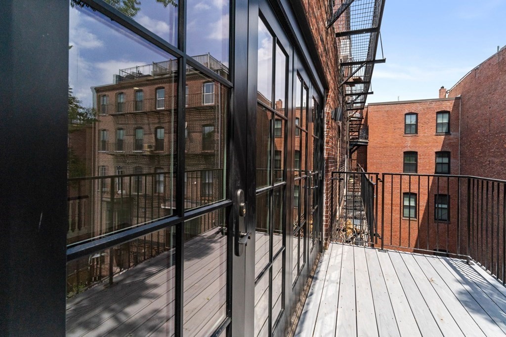 7 Columbus Square, Unit PH Boston, MA 02116 - Photo 24 of 28 a view of a balcony with wooden floor and fence