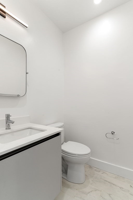 7 Columbus Square, Unit PH Boston, MA 02116 - Photo 9 of 28 a bathroom with a toilet a sink and mirror