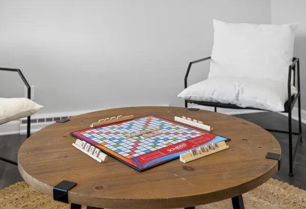 a spacious bedroom with a bed and a lamp