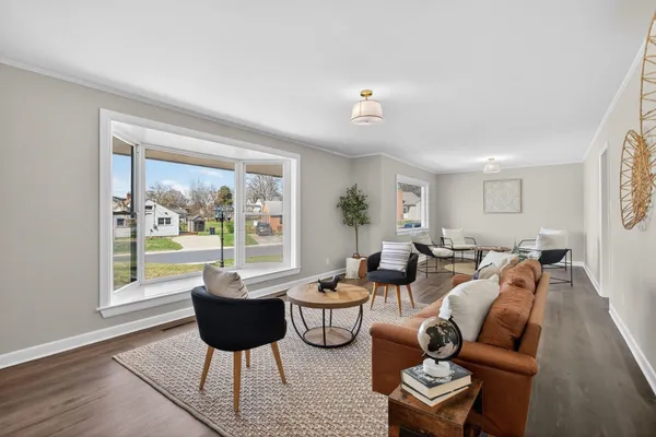 a dining room with wooden floor a chandelier a glass table and chairs