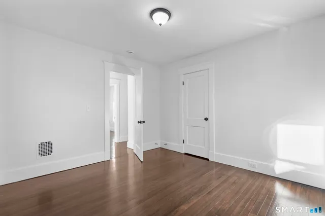 a view of room with hardwood floor and window