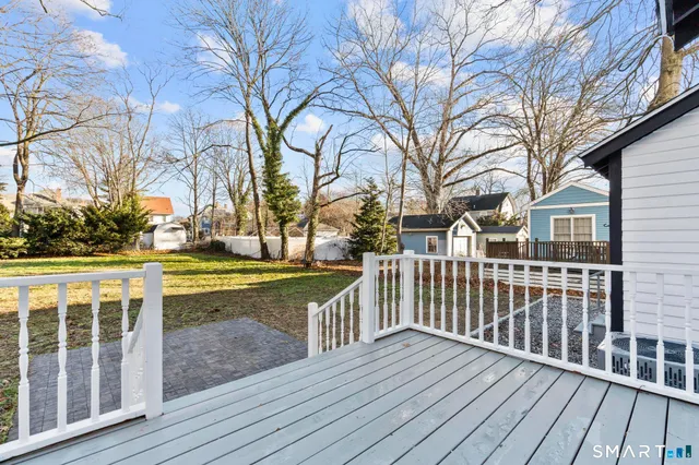 a view of a wooden deck with a yard