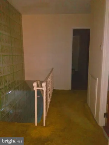 a bed sitting in a spacious bedroom next to a window