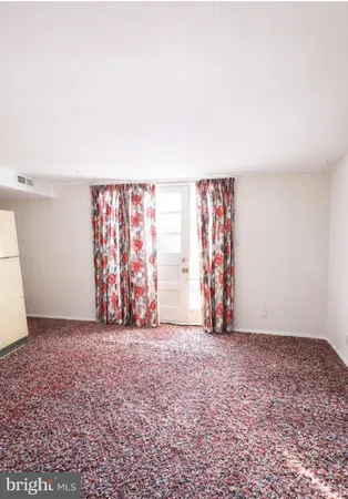a view of a bedroom with a bed and wooden floor