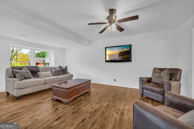 a living room with furniture and a wooden floor