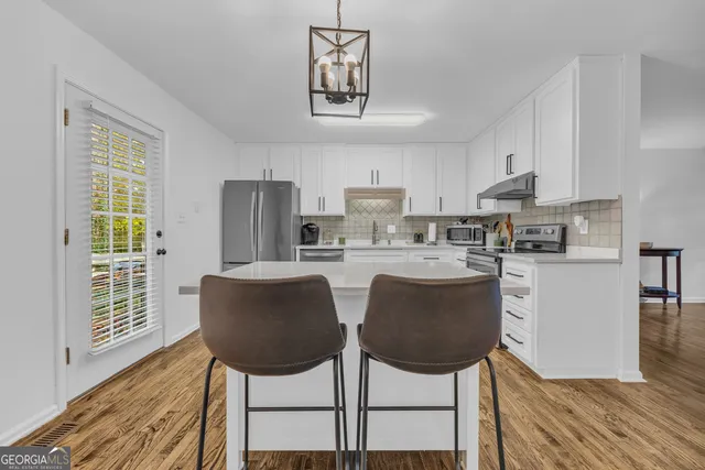 a kitchen with a stove and a microwave