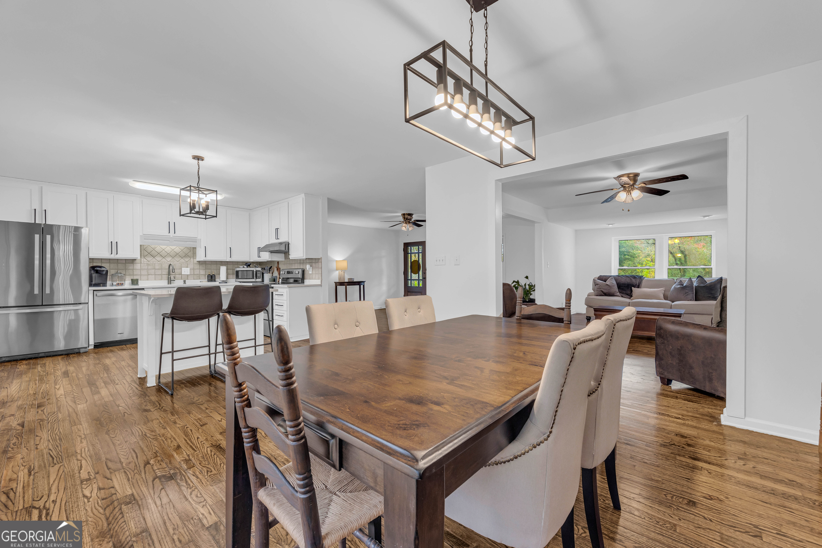 619 Watson Street Toccoa, GA 30577 - Photo 19 of 28 a view of a dining room and livingroom with furniture wooden floor a chandelier
