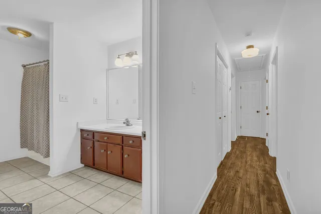 a spacious bathroom with a granite countertop sink mirror and toilet