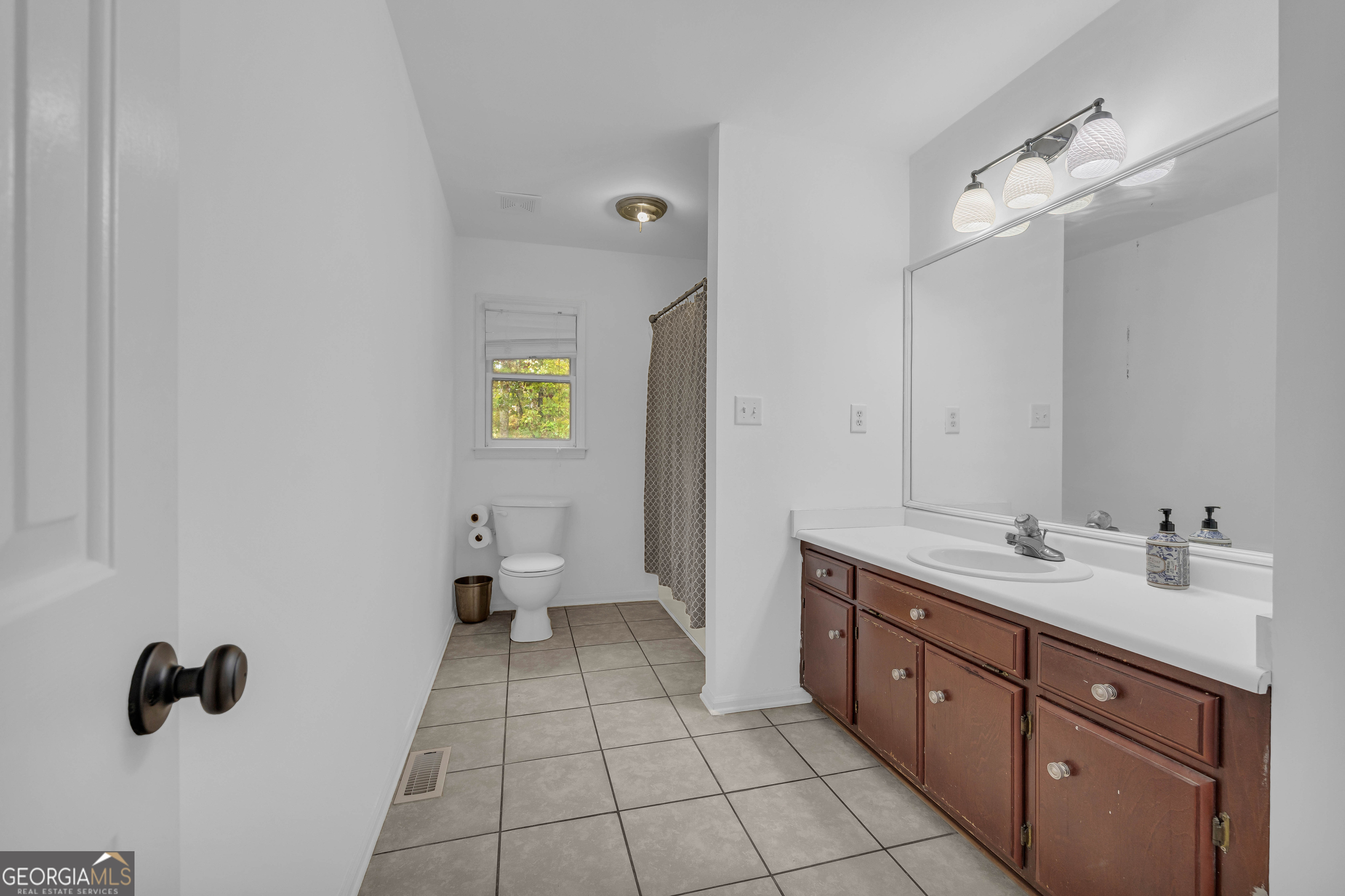 619 Watson Street Toccoa, GA 30577 - Photo 21 of 28 a spacious bathroom with a granite countertop sink mirror and toilet