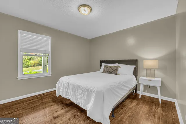 a bedroom with a bed and a dresser in it