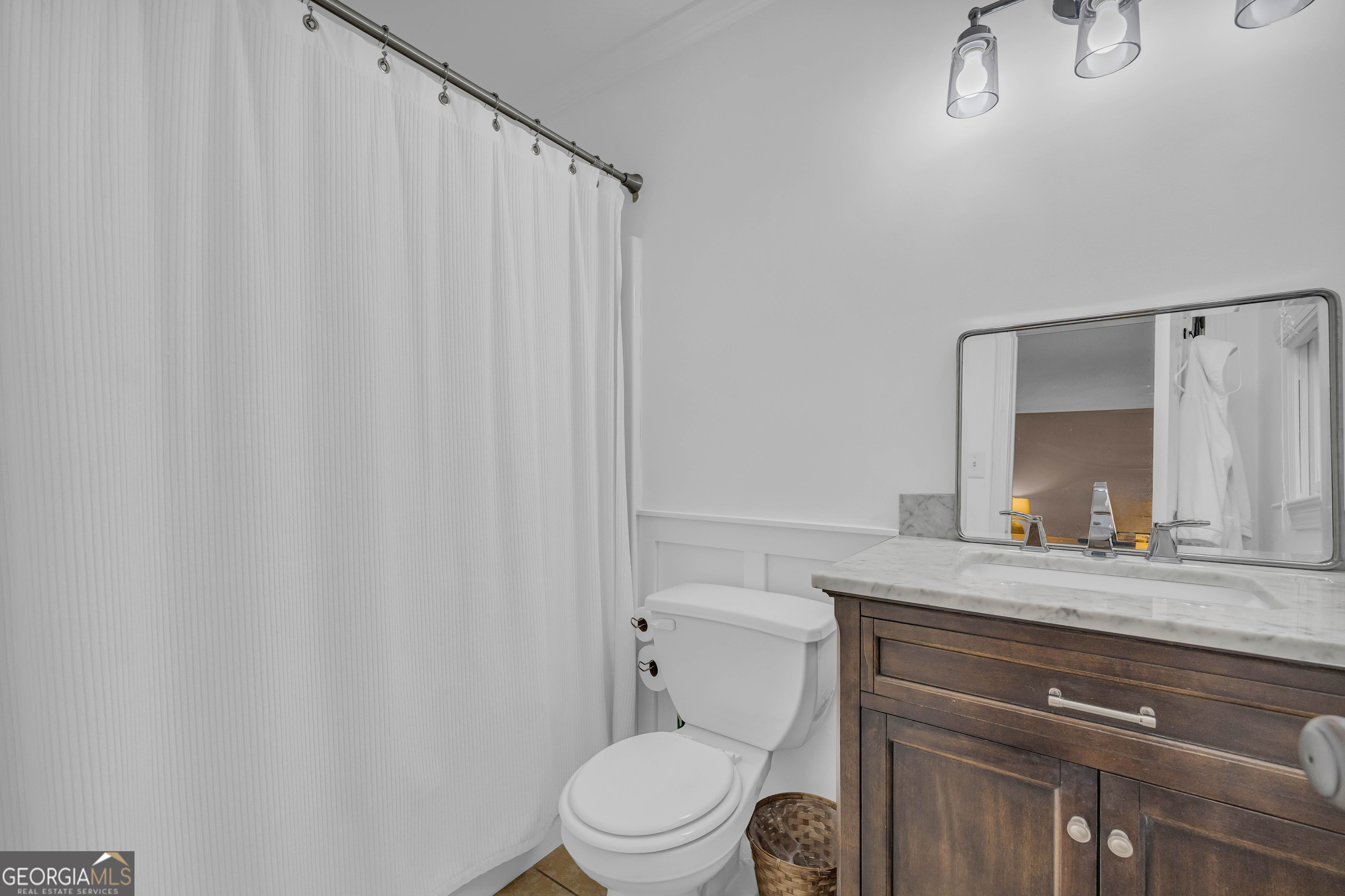 619 Watson Street Toccoa, GA 30577 - Photo 6 of 28 a bathroom with a granite countertop sink vanity mirror and toilet