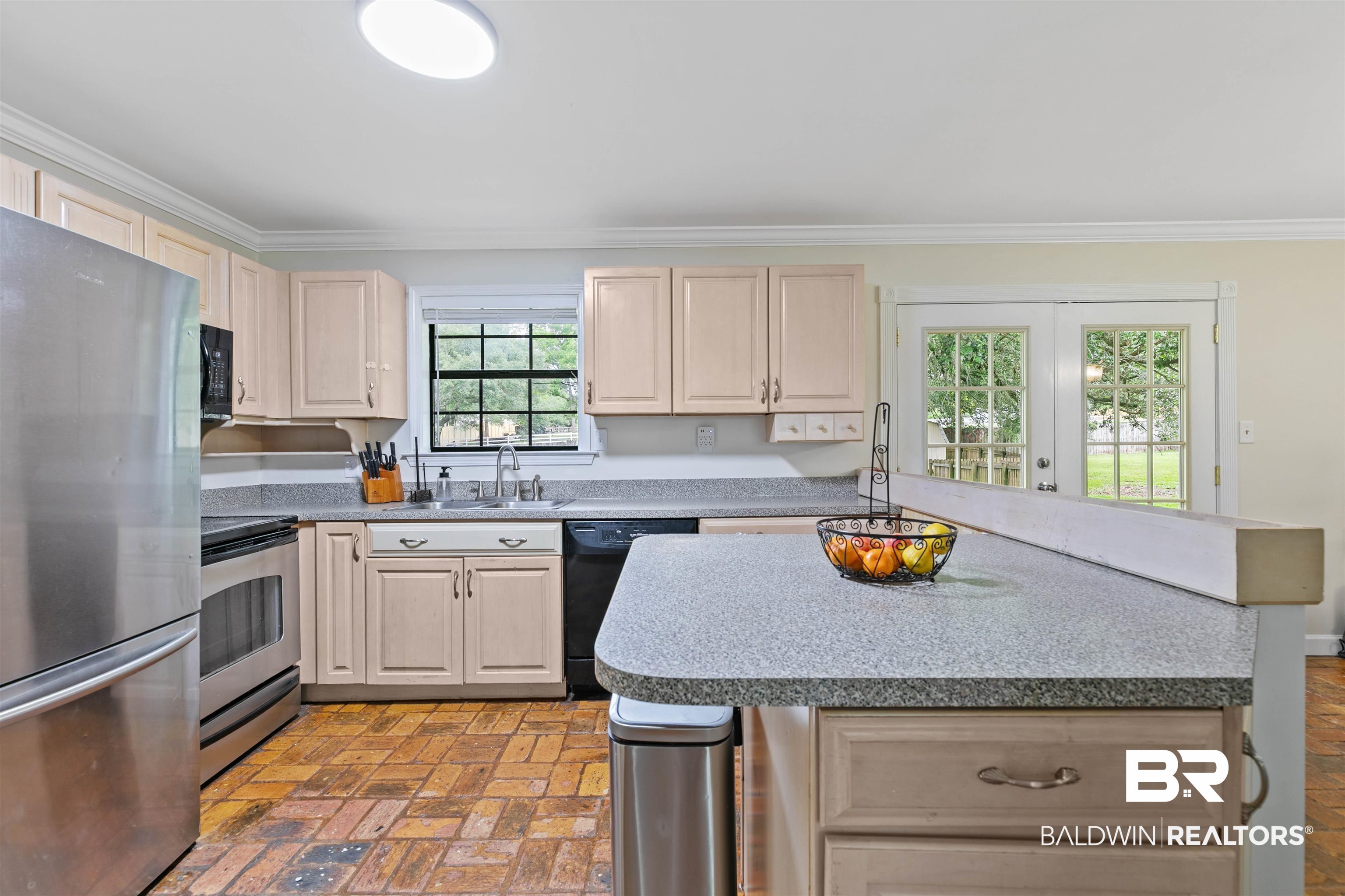 10420 Johnson Road South Mobile, AL 36695 - Photo 20 of 75 Kitchen featuring light-toned cabinetry, granite-style countertops, stainless steel appliances, brick-finish flooring, and French doors leading to exterior