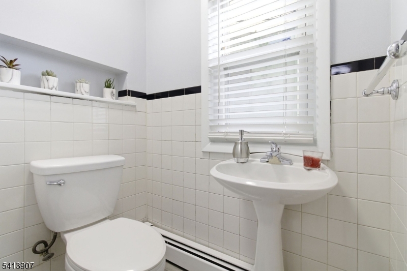 32 Cedar Avenue Elizabeth, NJ 07202 - Photo 23 of 32 a bathroom with a toilet sink and mirror