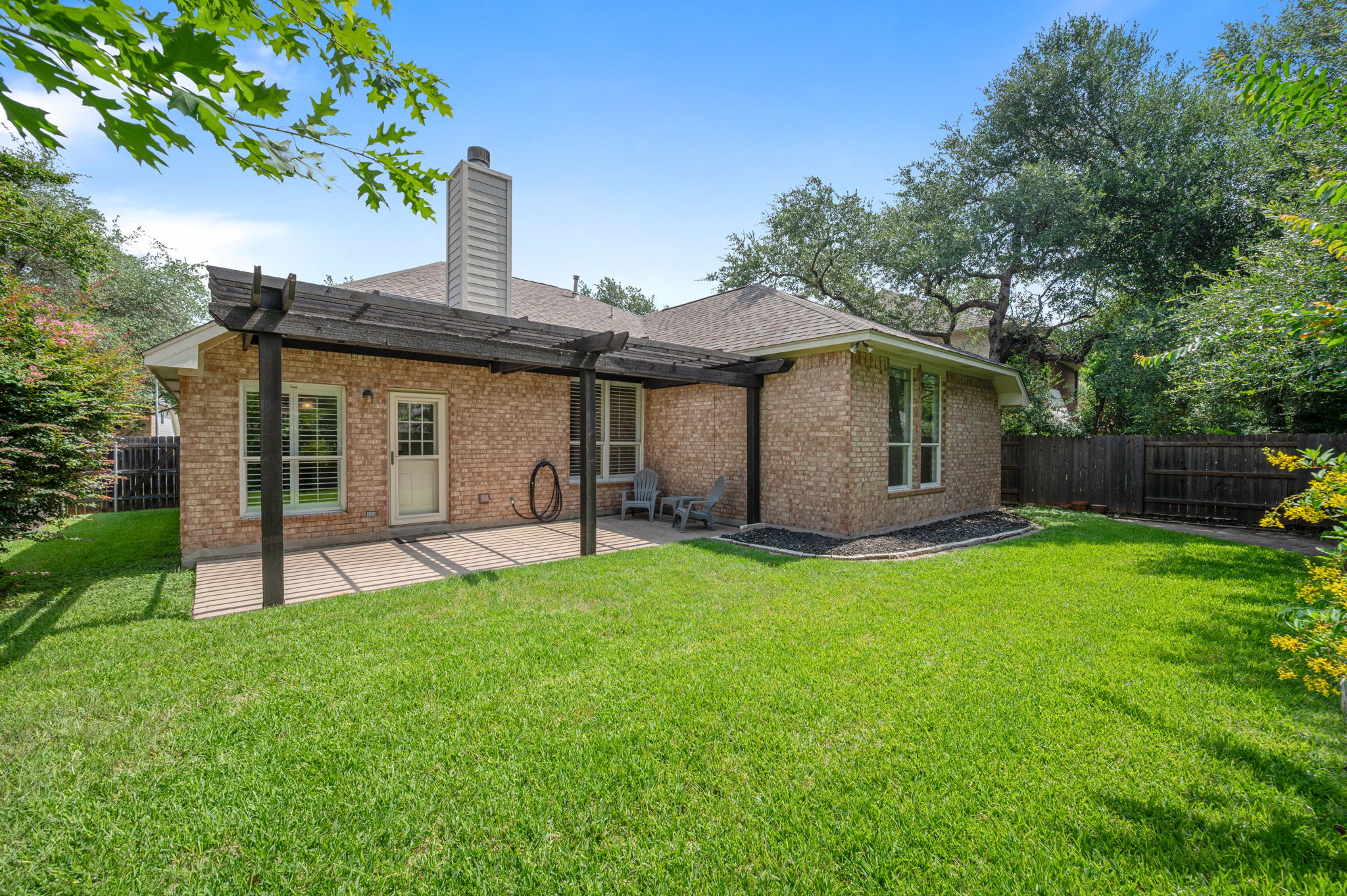 9201 La Siesta Bend Austin, TX 78749 - Photo 33 of 37 a view of a house with a yard and a garden