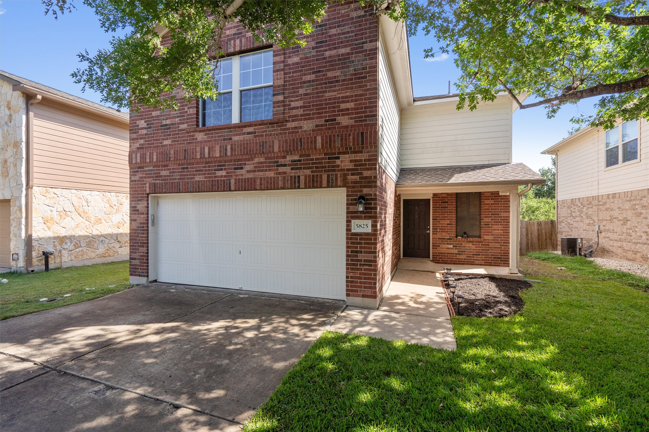 5825 Silver Screen Drive Austin, TX 78747 - Photo 4 of 40 A classic brick facade welcomes you home, boasting a functional two-car garage and tidy landscaping.