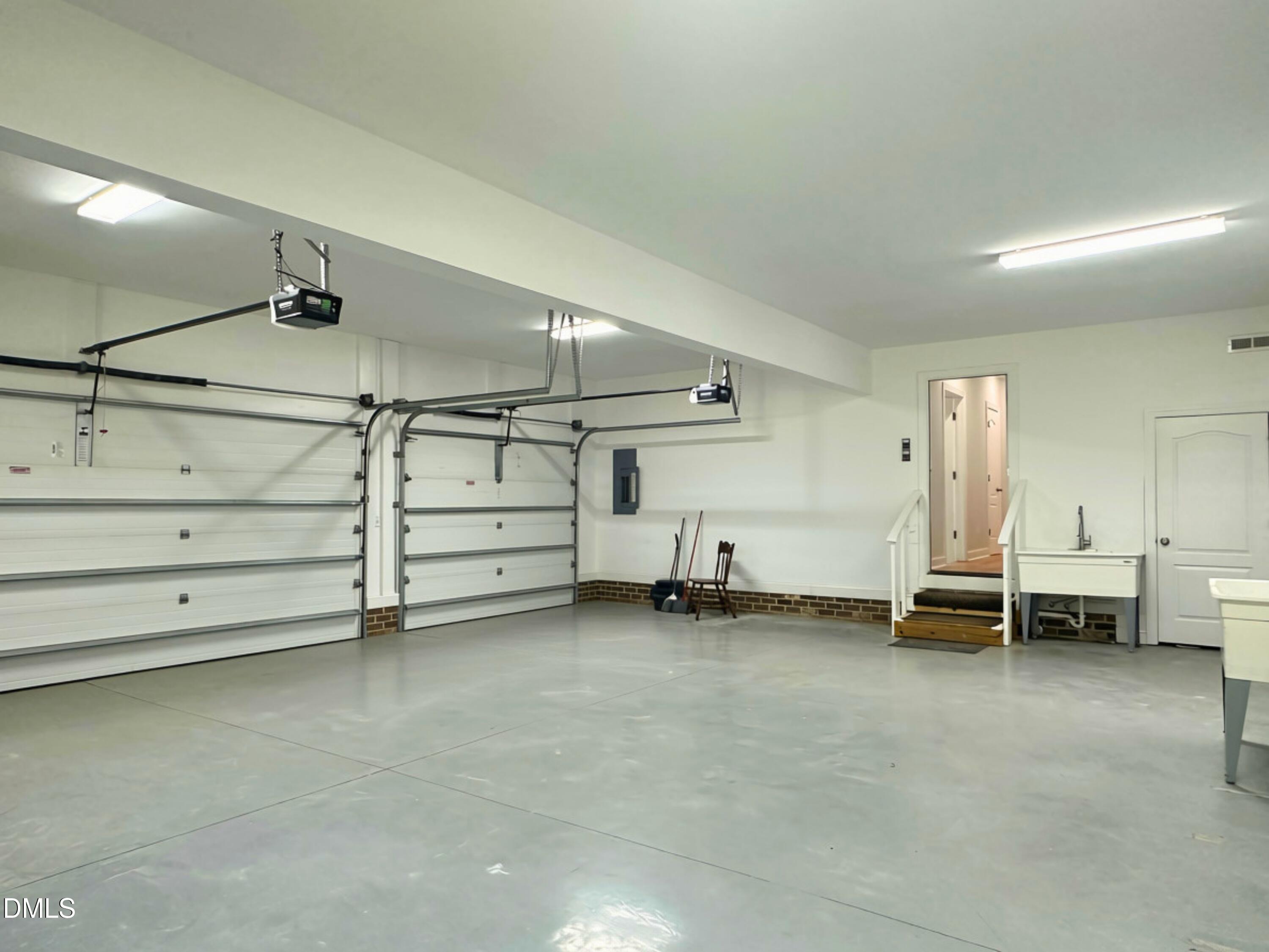 3100 Donlin Drive Wake Forest, NC 27587 - Photo 55 of 67 Two-bay garage with automatic door openers, painted concrete flooring, and a utility sink