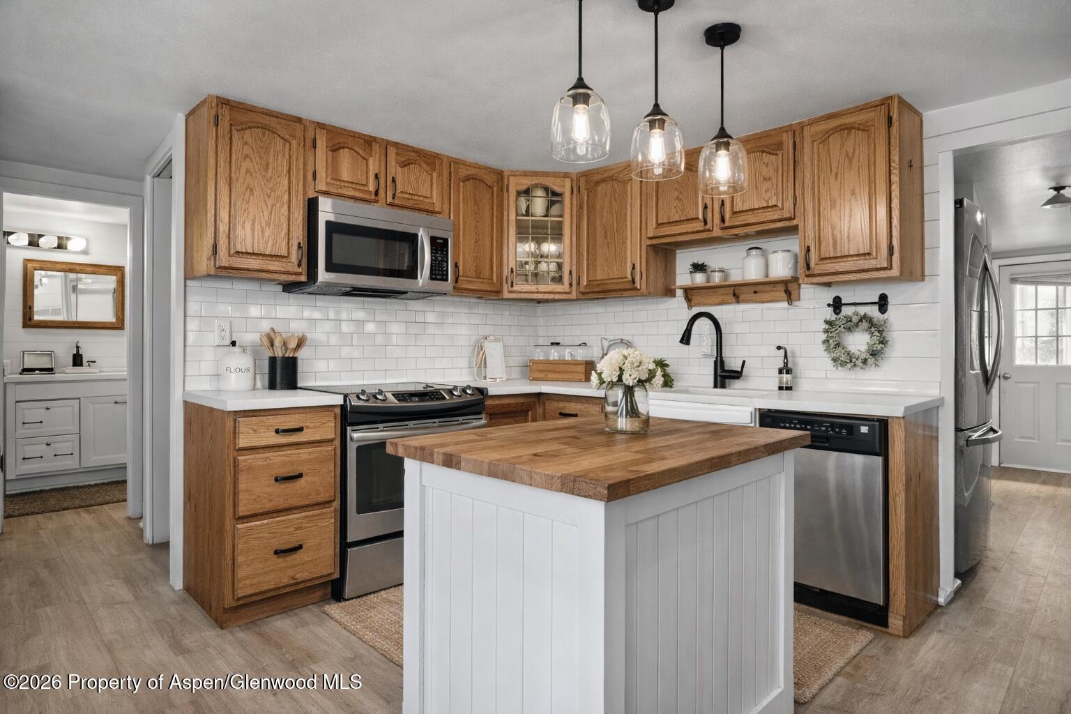 109 East 12th Street Rifle, CO 81650 - Photo 14 of 31 a kitchen with stainless steel appliances granite countertop a sink a stove and a refrigerator