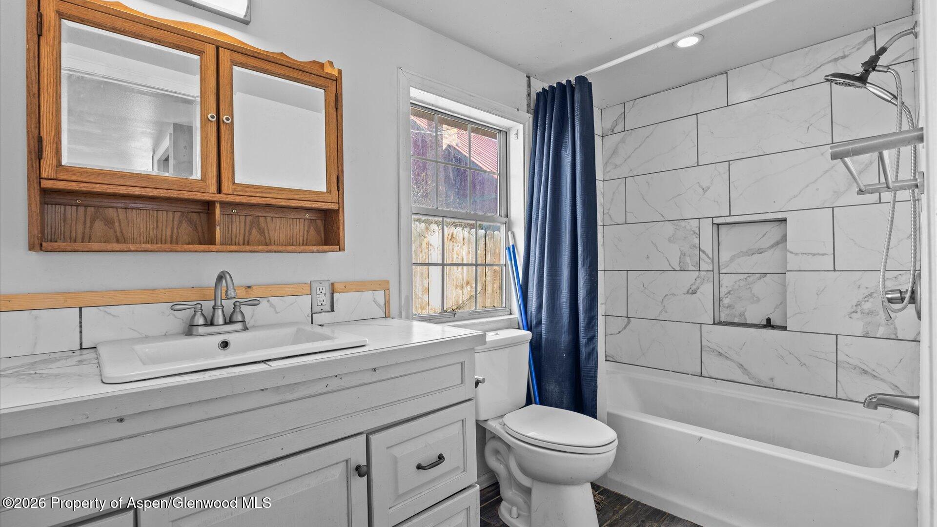 109 East 12th Street Rifle, CO 81650 - Photo 22 of 31 a bathroom with a sink toilet a mirror and shower