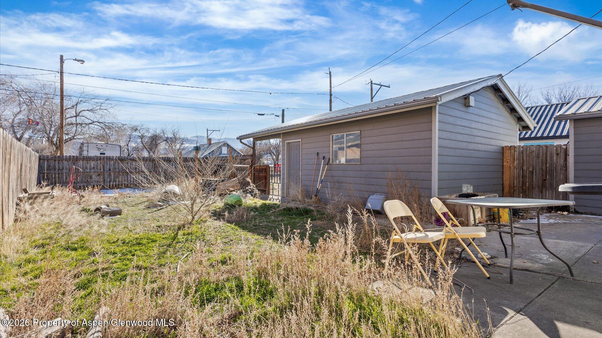 109 East 12th Street Rifle, CO 81650 - Photo 26 of 31 a backyard of a house with table and chairs