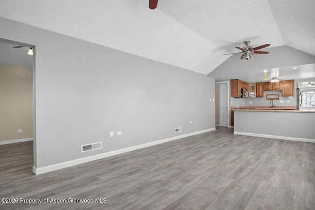 a view of a room with window and a ceiling fan