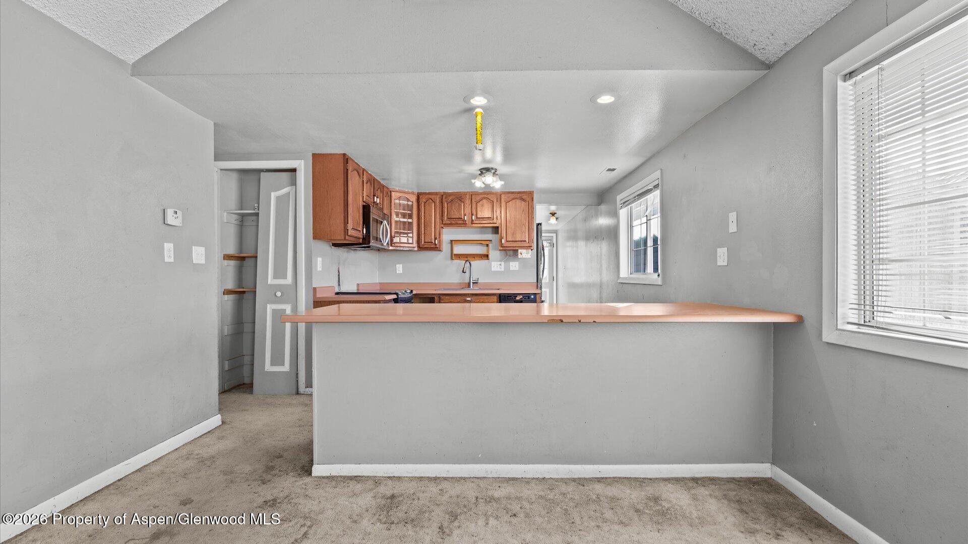 109 East 12th Street Rifle, CO 81650 - Photo 10 of 31 a kitchen with stainless steel appliances a sink stove and refrigerator