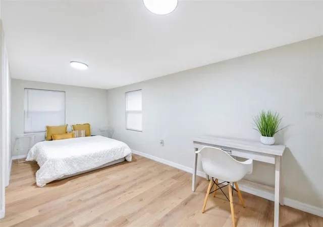 a bedroom with a bed and a chair