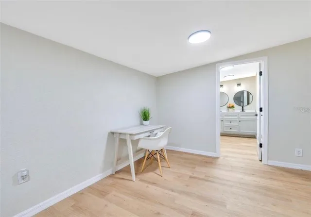a view of a room with wooden floor and a sink