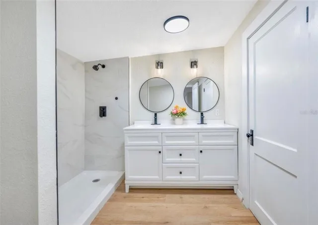 a bathroom with a tub sink and mirror