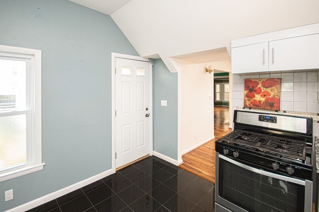 21 Carnes Street Lynn, MA 01905 - Photo 11 of 20 a room with wooden floor and a stove top oven