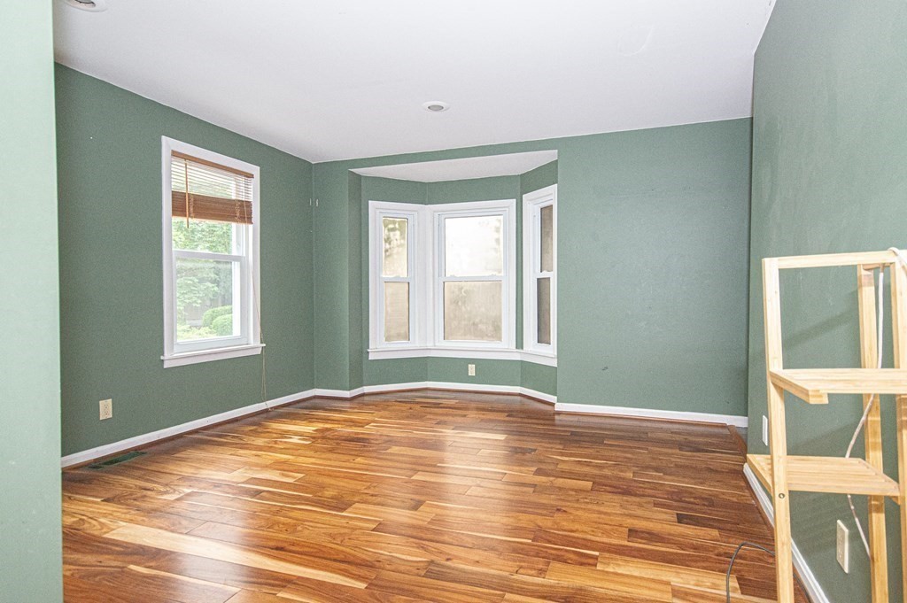 21 Carnes Street Lynn, MA 01905 - Photo 13 of 20 a view of an empty room with wooden floor and a window