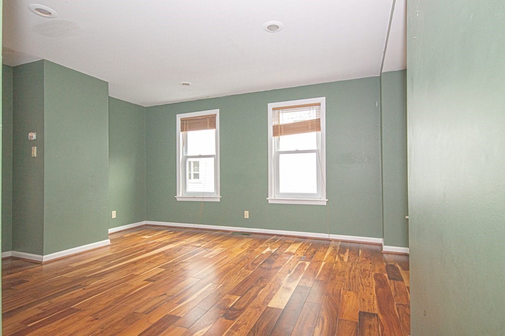 21 Carnes Street Lynn, MA 01905 - Photo 14 of 20 a view of an empty room with wooden floor and a window