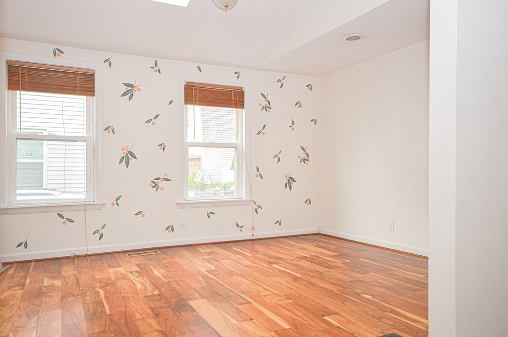 21 Carnes Street Lynn, MA 01905 - Photo 15 of 20 an empty room with wooden floor and windows