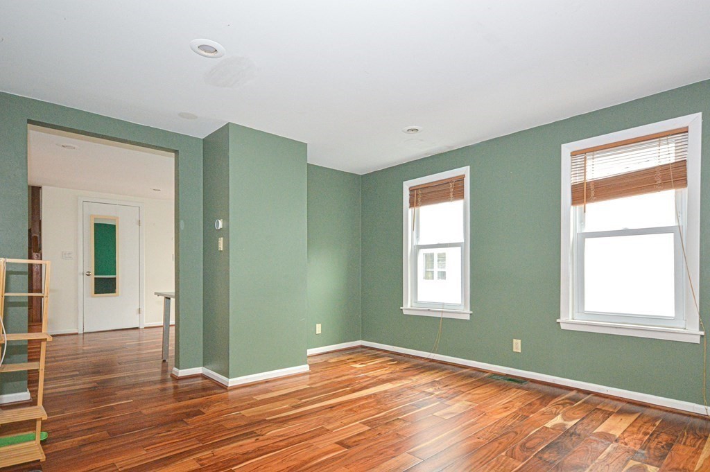21 Carnes Street Lynn, MA 01905 - Photo 3 of 20 a view of empty room with wooden floor and fan