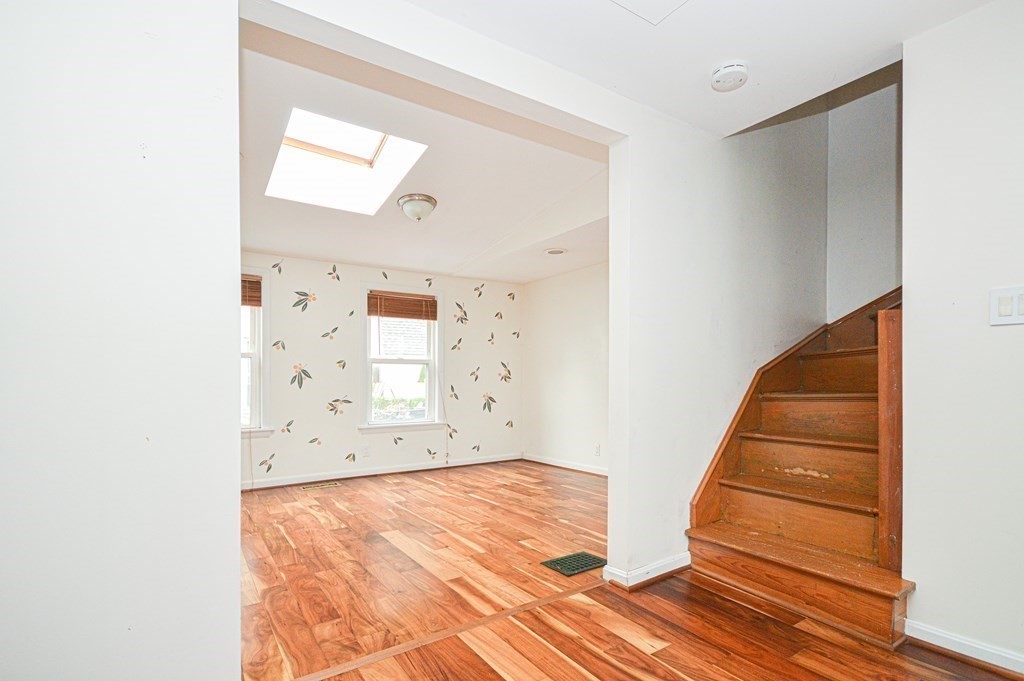 21 Carnes Street Lynn, MA 01905 - Photo 5 of 20 an empty room with wooden floor and windows