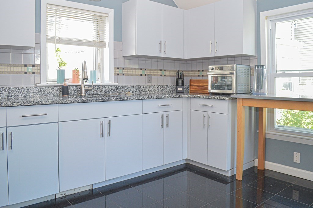 21 Carnes Street Lynn, MA 01905 - Photo 8 of 20 a kitchen with granite countertop white cabinets and white appliances